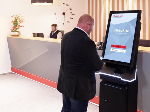 Man checks in digitally at reception 