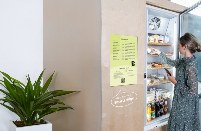 Woman takes out snack on Smartfridge