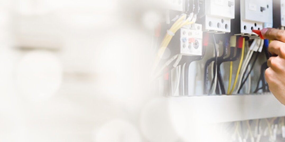 A close-up view of the electrical system of an employee with a measuring device
