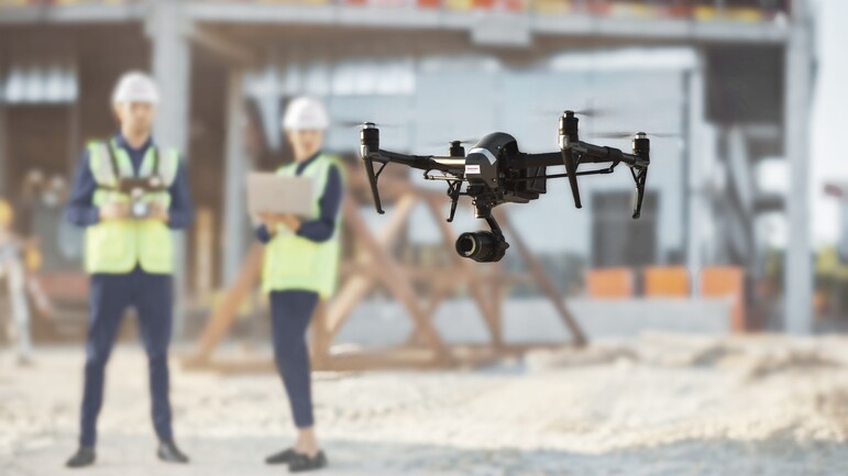 Drone on a construction site with Dussmann employees 