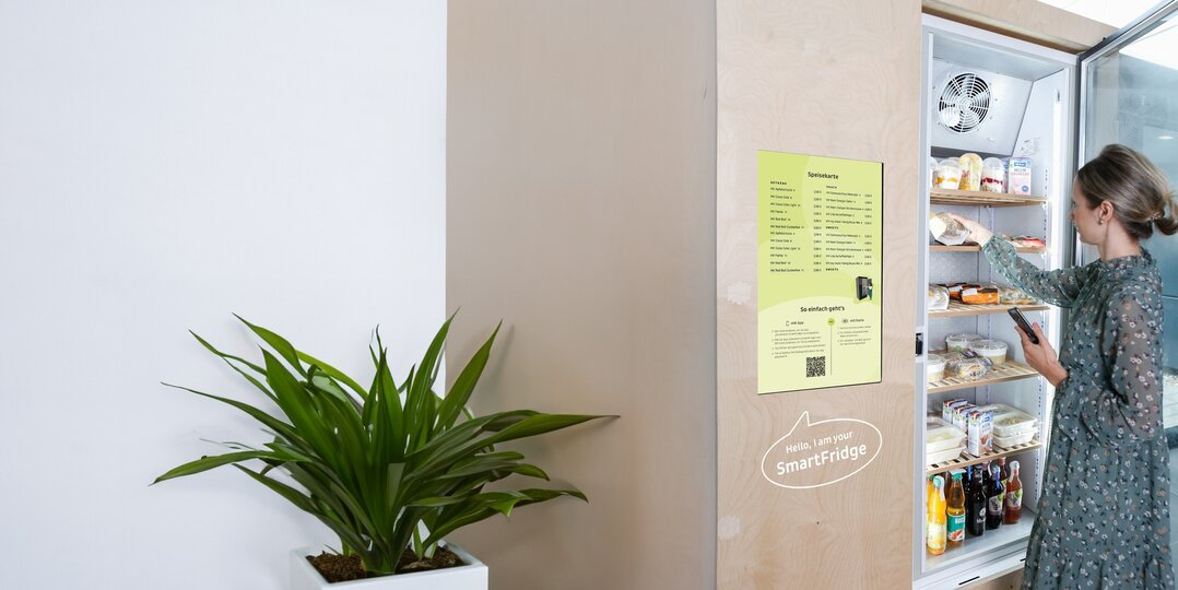 Woman takes snack from smartfridge