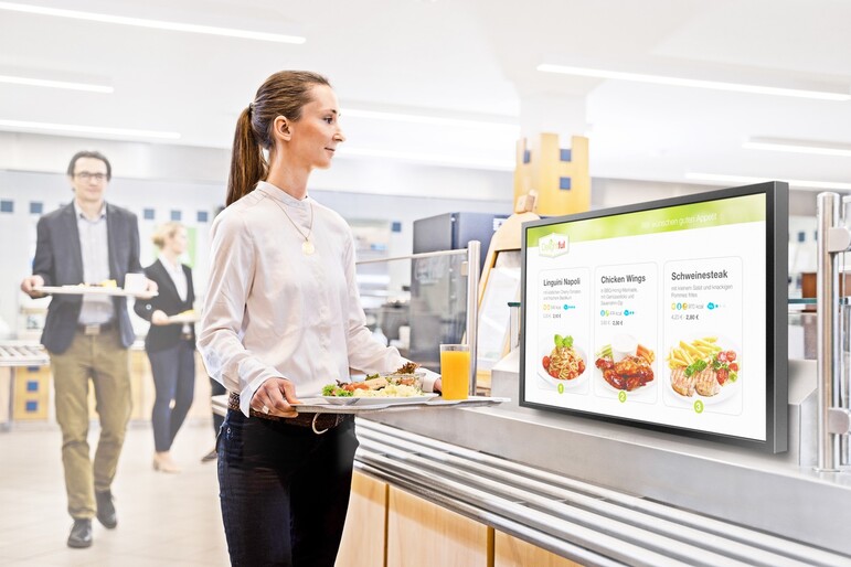 A woman with tray in a canteen