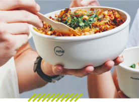 Person eats food from a bowl from the reusable supplier Vytal