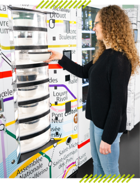 A woman gets her food from a food vending machine