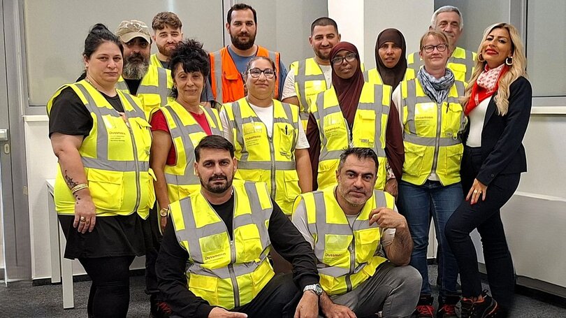 Women and men wearing yellow vests from Dussmann's building cleaning team | © Dussmann